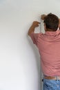 Senior man measured the wall with measuring tape and repairing the apartment Royalty Free Stock Photo