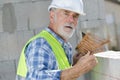 Senior man measuring wall with construction level Royalty Free Stock Photo