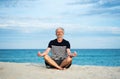 Senior man meditating on the beach Royalty Free Stock Photo