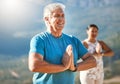 Senior man meditating with joined hands and closed eyes breathing deeply. Mature people doing yoga in nature living a Royalty Free Stock Photo