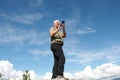 Senior man with mobile phone and blue sky background Royalty Free Stock Photo