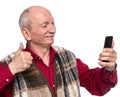 Senior man with mobile phone posing in studio Royalty Free Stock Photo
