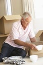 Senior Man Moving Home And Packing Boxes Royalty Free Stock Photo