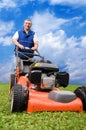 Senior man mowing the lawn.