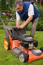 Senior man mowing the lawn