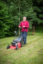 Senior man mowing the lawn Royalty Free Stock Photo