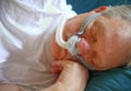 Man with sleep apnea uses breathing device