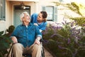 Senior man, nurse and wheelchair for healthcare support, life insurance or garden walk at nursing home. Happy elderly Royalty Free Stock Photo