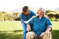 Senior man, nurse and wheelchair for life insurance, healthcare support or garden at nursing home. Happy elderly male Royalty Free Stock Photo