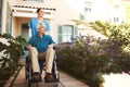 Senior man, nurse and wheelchair for walk, relax or healthcare support in garden at nursing home. Happy elderly male and Royalty Free Stock Photo