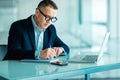 Senior man working on laptop computer in office Royalty Free Stock Photo