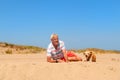 Senior man with old dog at beach Royalty Free Stock Photo