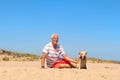 Senior man with old dog at beach Royalty Free Stock Photo