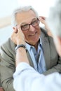 Senior man in optical store Royalty Free Stock Photo