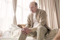 Senior man with osteoarthritis pain holding hands on his knee Royalty Free Stock Photo