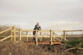 Senior man outdoors standing on a bridge thinking and daydreaming Royalty Free Stock Photo