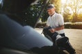 Senior man packing his golf clubs in a car trunk Royalty Free Stock Photo