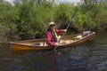 Senior man paddling a small canoe on the Moose River. Royalty Free Stock Photo
