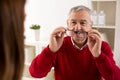 Senior man patient takes glasses aftere change of diopter Royalty Free Stock Photo
