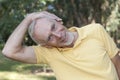Senior man performing neck stretch