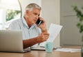 Senior man on a phone call with finance documents for debt counselling. Old male at home with his laptop and paperwork Royalty Free Stock Photo