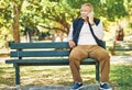 Senior man, phone call and park with conversation and bench outdoor with communication. Nature, discussion and mobile Royalty Free Stock Photo