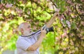 Senior man photographer blooming trees background. Cameraman retirement. Professional photographer. Capturing moments