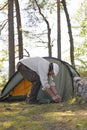 Senior man pitches a tent