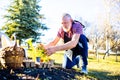 Senior man planting a plants in garden outdoors spring season ready Royalty Free Stock Photo