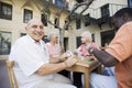 Senior Man Playing Cards With Friends Royalty Free Stock Photo