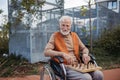 Senior man playing chess outdoors alone. Nursing home client, enjoying game of solitaire chess, chess puzzle. Royalty Free Stock Photo
