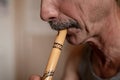 senior man playing the flute. faceless unprofessional male of elderly caucasian recorder