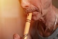 senior man playing the flute. faceless unprofessional male of elderly caucasian recorder