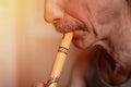 senior man playing the flute. faceless unprofessional male of elderly caucasian recorder