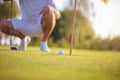 Senior man playing golf. Focus is on ball. Royalty Free Stock Photo