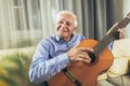 Senior man playing guitar at home Royalty Free Stock Photo