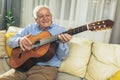 Senior man playing guitar at home Royalty Free Stock Photo