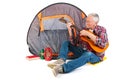 Senior man playing guitar by tent Royalty Free Stock Photo