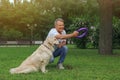 Happy senior man playing with his Golden Retriever dog in park Royalty Free Stock Photo