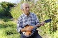 Senior man playing mandolin Royalty Free Stock Photo