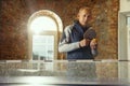 Senior man playing table tennis in workplace, having fun Royalty Free Stock Photo