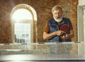 Senior man playing table tennis in workplace, having fun Royalty Free Stock Photo