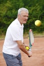 Senior man playing tennis Royalty Free Stock Photo