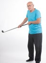 Senior man on white background plays golf