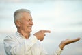 Senior man pointing on sky background Royalty Free Stock Photo