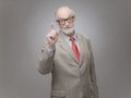Senior man points finger up Royalty Free Stock Photo