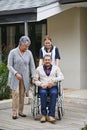 Senior, man and portrait of support in nursing home with partner and nurse for person a disability in wheelchair Royalty Free Stock Photo