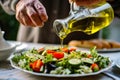 senior man pouring olive oil on a mediterraneanstyle salad Royalty Free Stock Photo