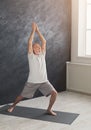 Senior man practicing yoga indoors Royalty Free Stock Photo