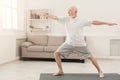 Senior man practicing yoga indoors Royalty Free Stock Photo